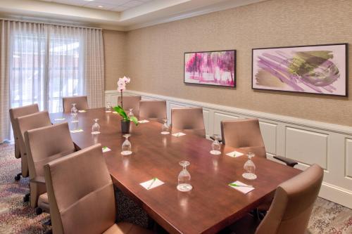 a conference room with a wooden table and chairs at Courtyard Clemson in Clemson