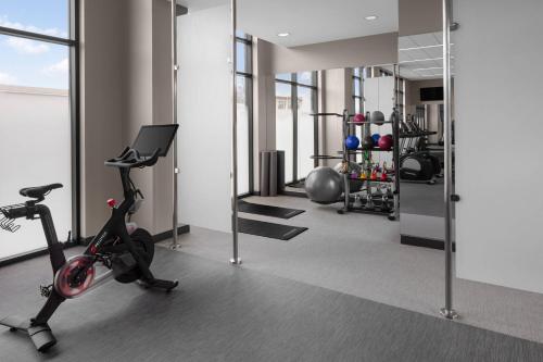 a gym with a treadmill and a exercise bike at Courtyard by Marriott Lansing Downtown in Lansing