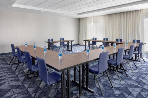 a conference room with tables and chairs with water bottles on them at Courtyard by Marriott Lansing Downtown in Lansing