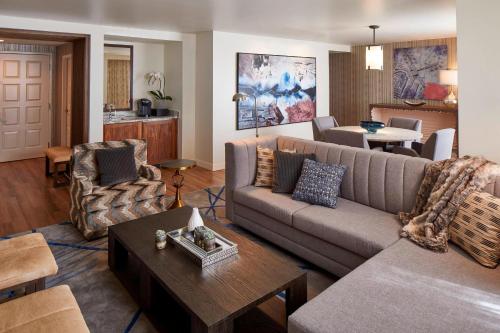 a living room with a couch and a table at Renaissance Dallas Hotel in Dallas