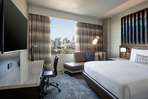 a hotel room with a bed and a window at Renaissance Dallas Hotel in Dallas