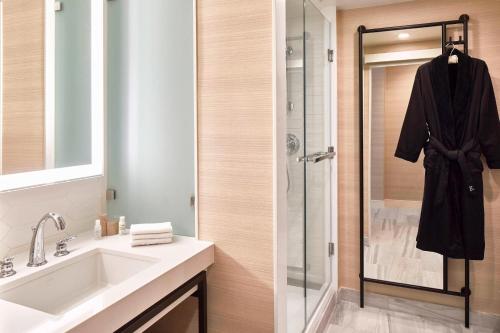 a bathroom with a sink and a shower at Renaissance Dallas Hotel in Dallas