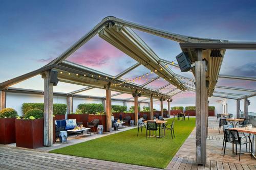 patio with tables and chairs on a lawn at Renaissance Dallas Hotel in Dallas