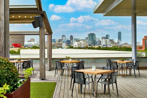 a patio with tables and chairs and a view of the city at Renaissance Dallas Hotel in Dallas