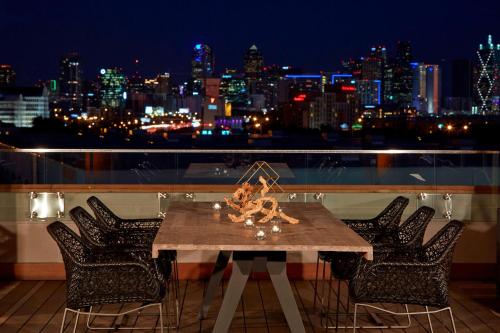 a table on a balcony with a view of a city at Renaissance Dallas Hotel in Dallas