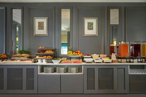 a buffet line with many different types of food at The College Green Dublin Hotel, Autograph Collection in Dublin