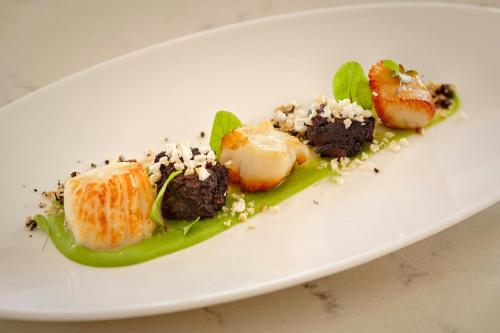 a white plate with some food on it at The College Green Dublin Hotel, Autograph Collection in Dublin