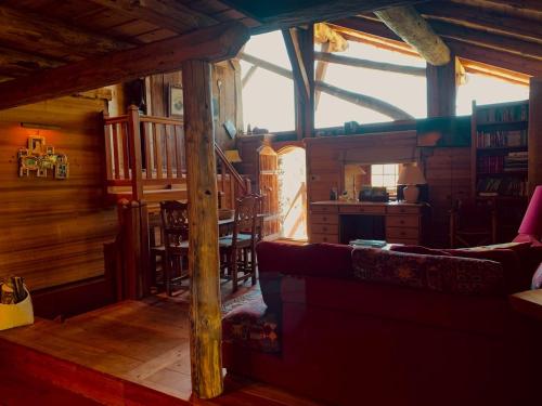 a living room with a couch and a dining room at Le Mouton Rouge - Superbe appartement avec terrasse in Séez