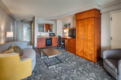 a living room with a couch and a table at Courtyard by Marriott Jacksonville Beach Oceanfront in Jacksonville Beach