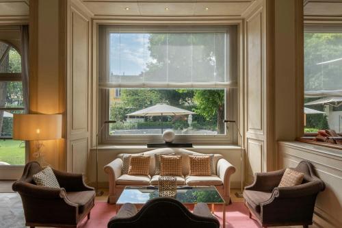 a living room with a couch and chairs and a window at Sina Villa Medici, Autograph Collection in Florence