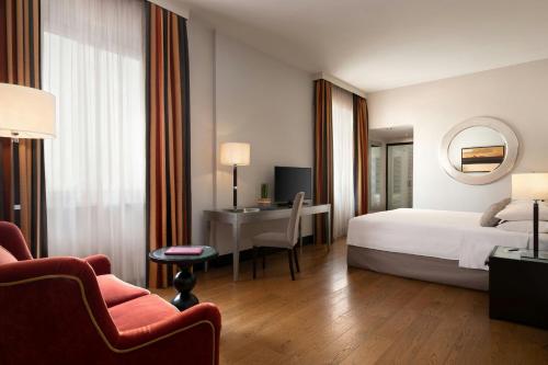 a hotel room with a bed and a desk at Sina Villa Medici, Autograph Collection in Florence