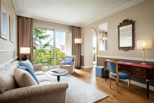 a living room with a couch and a desk at Sina Villa Medici, Autograph Collection in Florence
