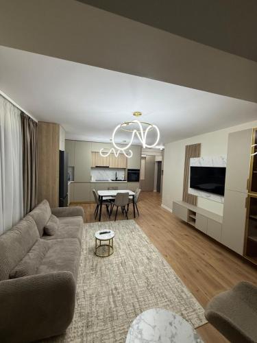a living room with a couch and a table at Sole Central Apartment in Râmnicu Vâlcea