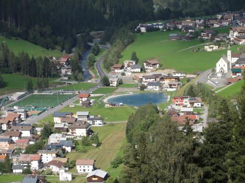 a village in the mountains with a lake at Apart Auhof in See