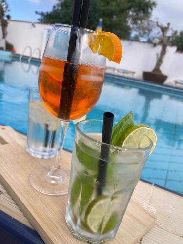 a drink in a glass sitting on a wooden table with a drink at Le Palme Holidays in Palmadula