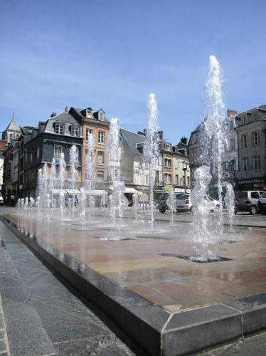 a group of water fountains in a city at La charmeuse in Tocqueville