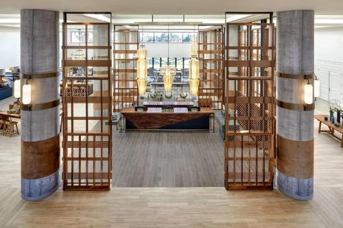 a library with wooden bookshelves and a desk at Westdrift Manhattan Beach, Autograph Collection in Manhattan Beach
