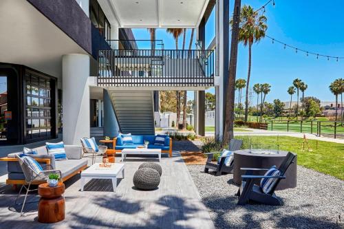 a patio with a lot of chairs and tables at Westdrift Manhattan Beach, Autograph Collection in Manhattan Beach