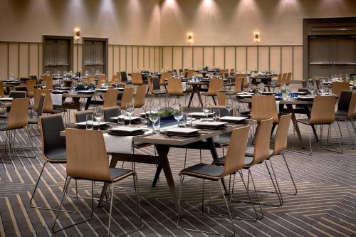 a large room with tables and chairs in it at Westdrift Manhattan Beach, Autograph Collection in Manhattan Beach
