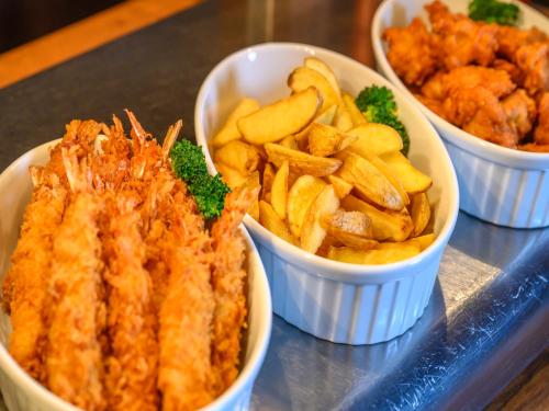 a tray with three bowls of food and fries at Dormy Inn Toyama Natural Hot Spring in Toyama