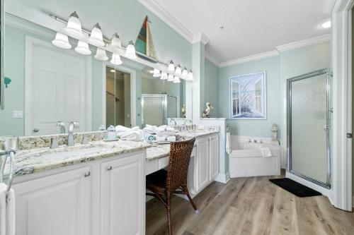 a bathroom with two sinks and a large mirror at Spanish Key 702 in Perdido Key