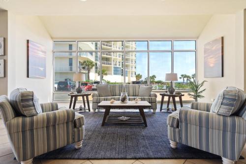 a living room with two couches and a table at Perdido Sun 304 in Perdido Key