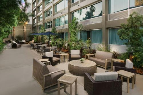 an outdoor patio with chairs and tables in a building at Courtyard by Marriott Los Angeles Woodland Hills in Woodland Hills