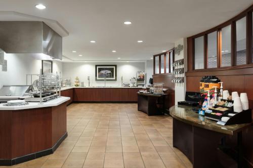 a large room with a kitchen with a counter at Courtyard by Marriott Wichita at Old Town in Wichita
