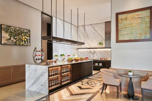a kitchen with a counter and a table and chairs at Sheraton Can Tho in Can Tho