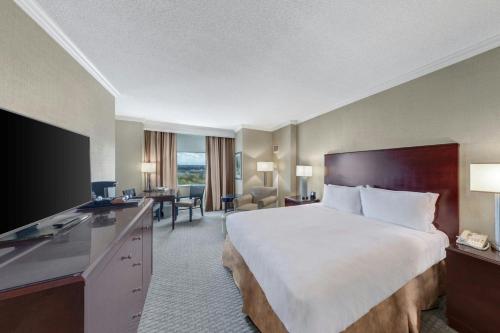 a hotel room with a large bed and a desk at Renaissance Dallas North Hotel in Dallas