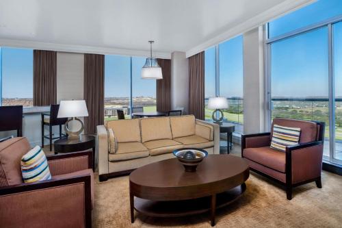 a living room with a couch and chairs and a table at Renaissance Dallas North Hotel in Dallas