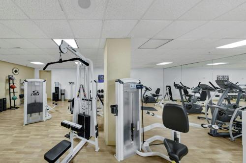 a gym with treadmills and ellipticals in a room at Renaissance Dallas North Hotel in Dallas