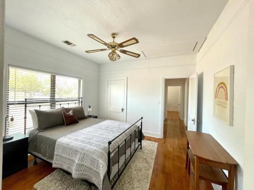 a bedroom with a bed and a ceiling fan at Courthouse Corner - Beautiful adobe, pet friendly in Marfa