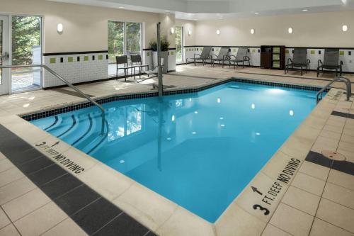 a large pool with blue water in a hotel at Fairfield Inn & Suites by Marriott Carlisle in Carlisle