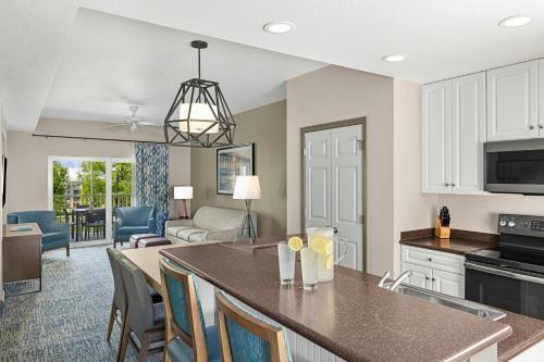 a kitchen and living room with a table and chairs at Sheraton Broadway Resort Villas in Myrtle Beach
