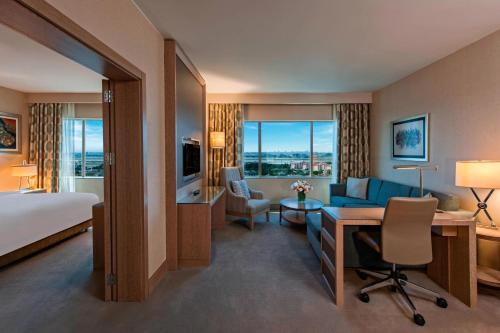 a hotel room with a bed and a desk and a room at Renaissance Polat Istanbul Hotel in Istanbul