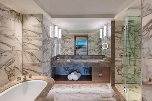 a bathroom with a tub and a sink at Renaissance Polat Istanbul Hotel in Istanbul