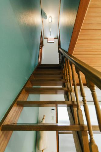 a staircase in a house with wooden railings at 春日舎 KASUGASYA-Kyoto in Kyoto