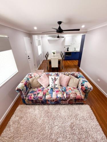 a living room with a couch and a table at Chic Retreat Vintage and Modern in Garbutt Station