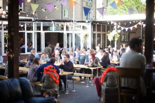 a group of people sitting at tables in a restaurant at 2bed 2bath 8min to London Bridge in London