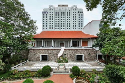 a building with a tall building in the background at Sheraton Hanoi Hotel in Hanoi