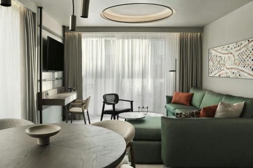a living room with a couch and a table at MonAsty, Thessaloniki, Autograph Collection in Thessaloniki