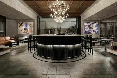 a bar in a restaurant with tables and chairs at MonAsty, Thessaloniki, Autograph Collection in Thessaloniki