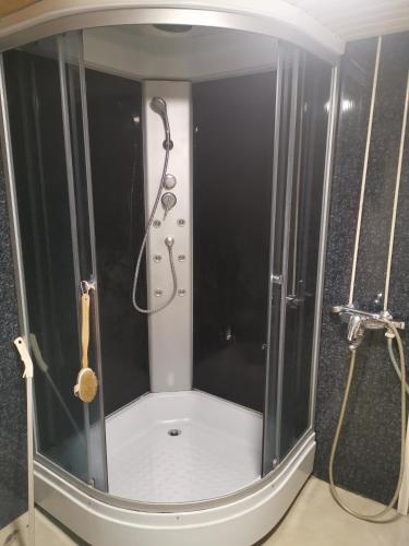 a shower with a shower head in a bathroom at Talo Ristiinassa in Mikkeli