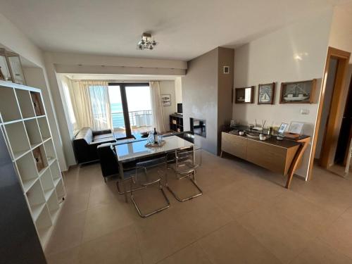 a living room with a table and a couch at Sea and Sun Luxury apartment in Neoi Epivates