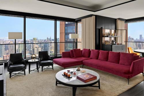 a living room with a red couch and chairs at Bulgari Hotel Shanghai in Shanghai