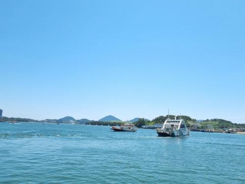 two boats in a large body of water at Yeosu UTOP UBLESS All Rooms Stunning Ocean View in Yeosu