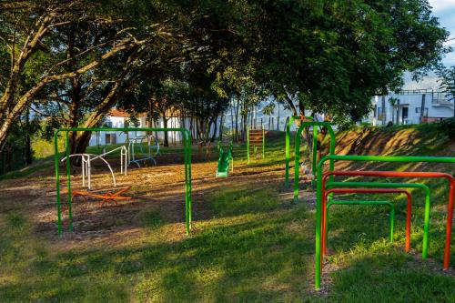 a playground in a park with green and colorful poles at Casas Campestres Los Miradores de Fruworld in Carmen de Apicalá