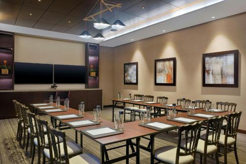 a conference room with a long table and chairs at Lapita, Dubai Parks and Resorts, Autograph Collection in Dubai