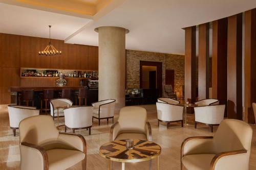 a lobby with chairs and a table and a bar at Park Chalet, Shahdag, Autograph Collection in Shahdag